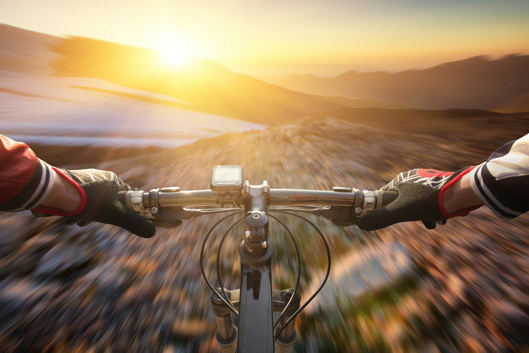 A mountain bike ride during sunset. A fast ride. Sport in the mountain region. Extreme sports.