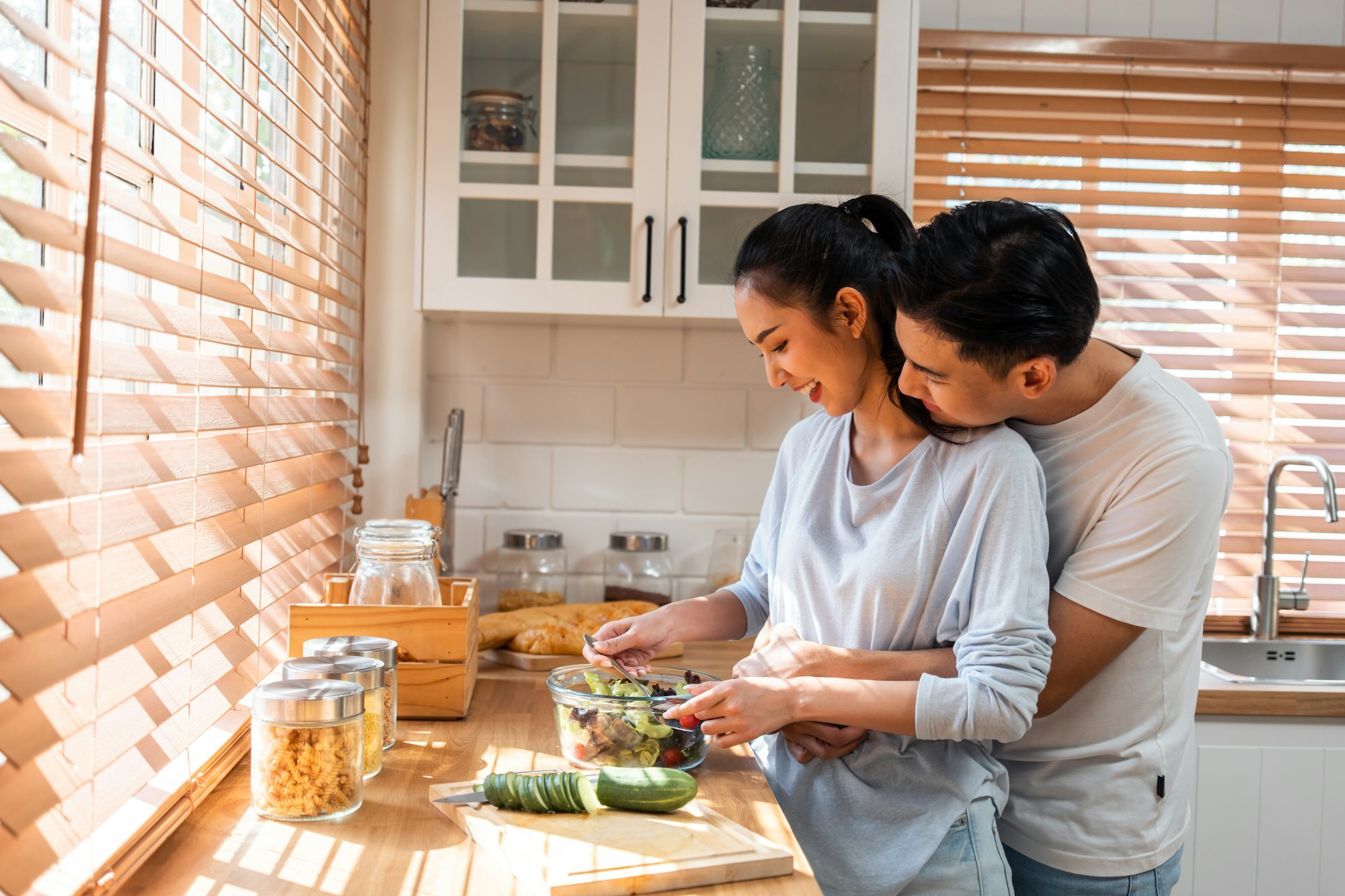 Asian young new marriage couple spend time together in kitchen at home.