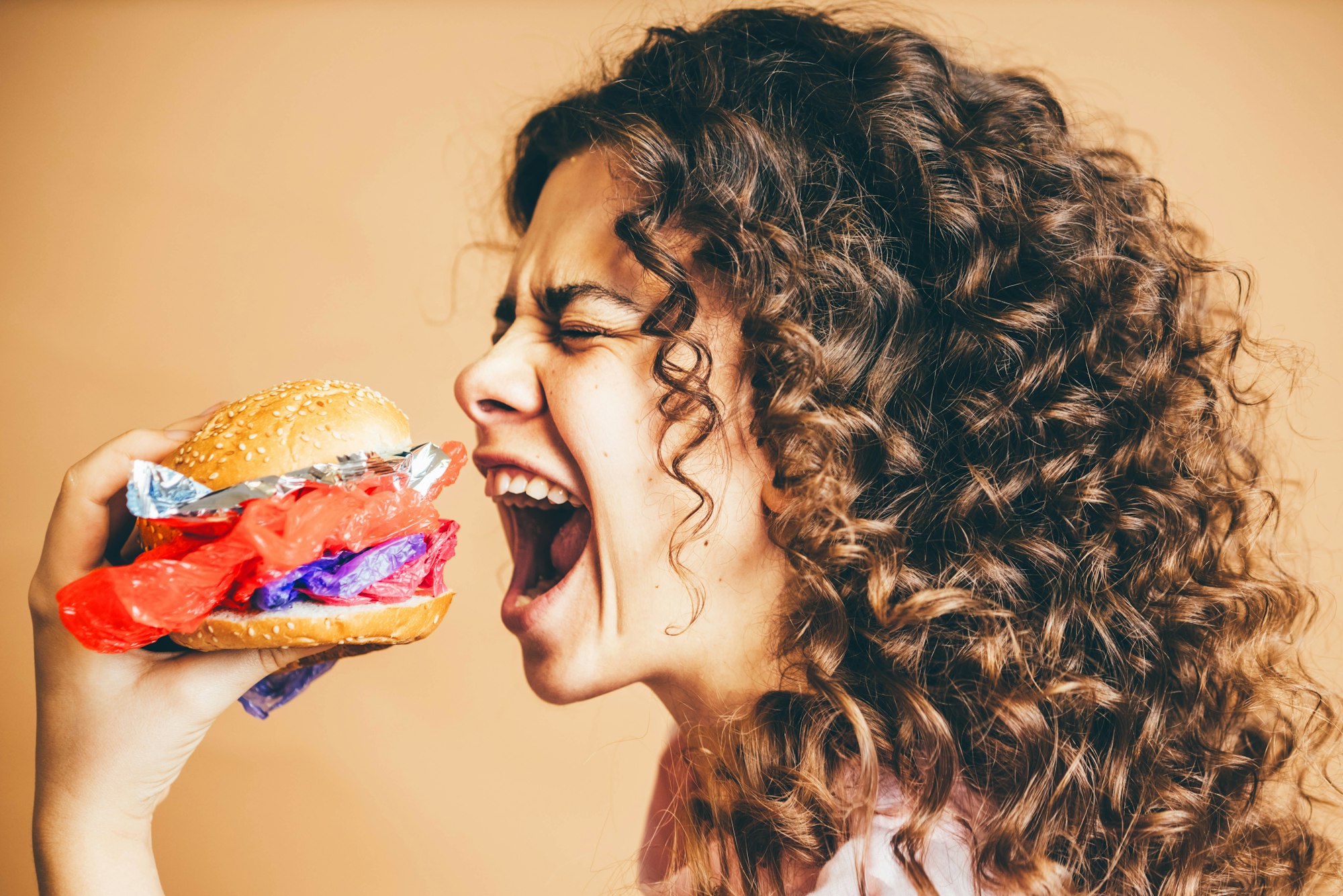 Woman eating plastic burgers